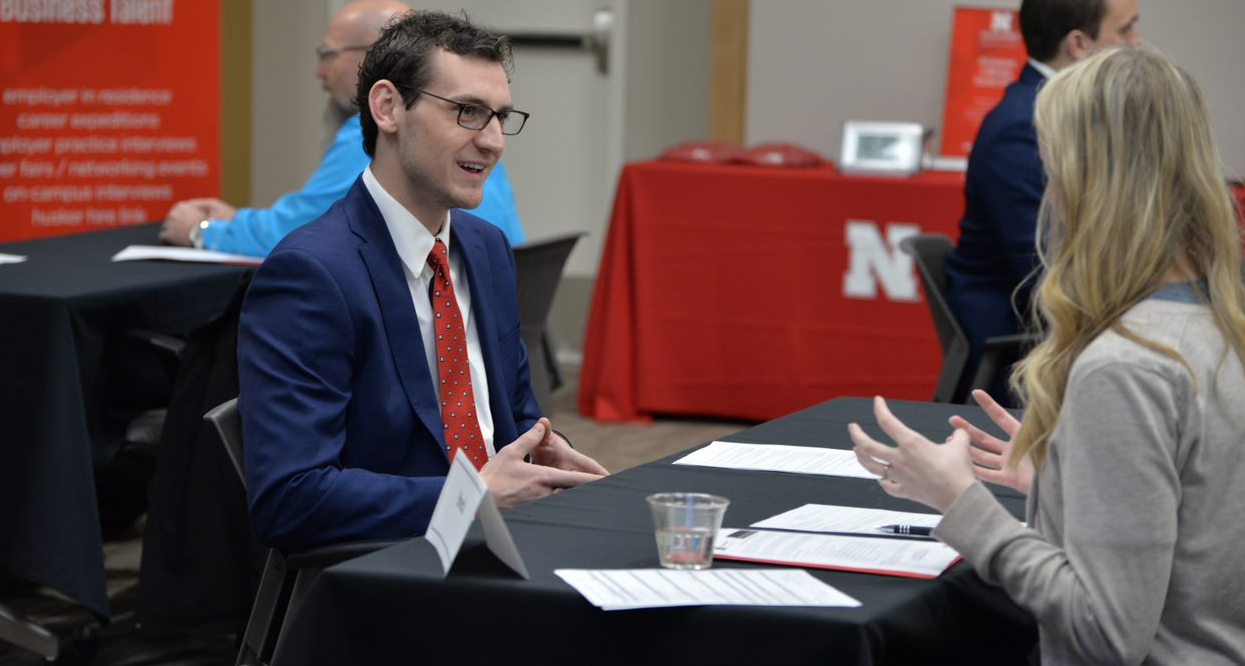 Student talks to an employer during interview event