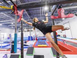 Leigh Jahnke flies through the air as she works her way across the apparatus using grabs called “wingnuts.” Jahnke is participating on America Ninja Warrior television competition. The senior and 2021 homecoming royalty also appeared on the show her fresh
