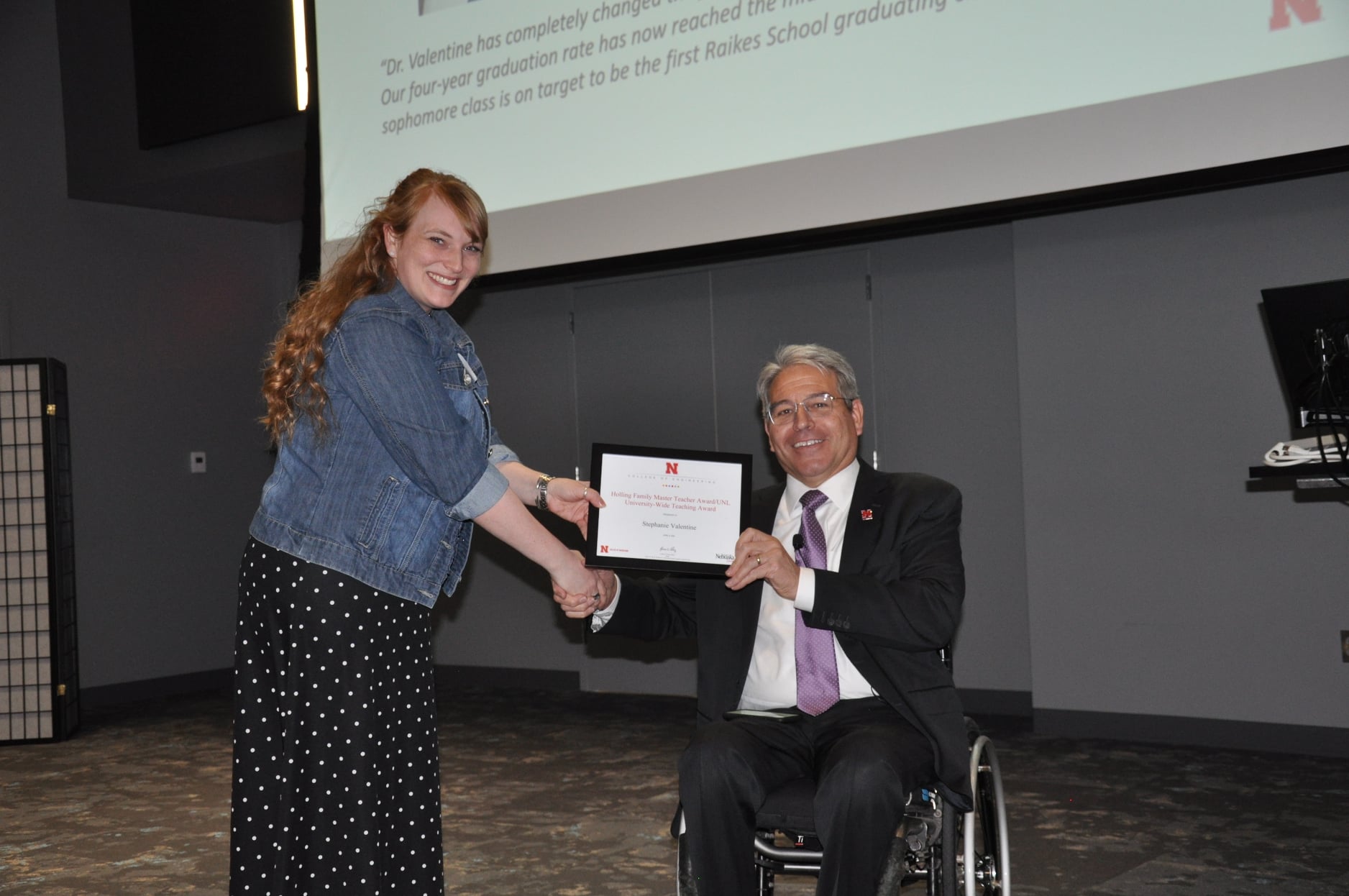 Stephanie Valentine accepts her award from College of Engineering Dean Lance Perez at the 2022 Employee Awards ceremony on April 8.