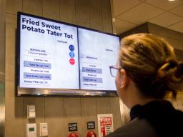 Customer views the menu board in the Cather Dining Center.