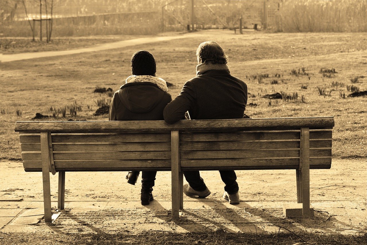 Two people sitting together on a bench