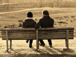 Two people sitting together on a bench