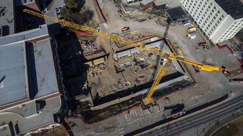 A crane towers over the site of Kiewit Hall, which is under construction at the corner of 17th and Vine streets.