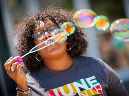 Charlie Foster, assistant vice chancellor for inclusive student excellence, blows a series of bubbles across the Nebraska Union Plaza during the university’s inaugural celebration of Juneteenth. [Craig Chandler | University Communication and Marketing]