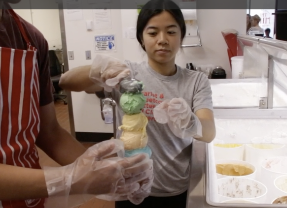 Vi Tran, a senior in actuary science, serves up a cone of Clover 4-H Mint at the Dairy Store on July 18. The university’s Dairy Store team churns out between 200 and 400 gallons of ice cream each week.