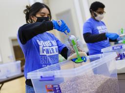 Cynthia Serrano-Ortega (left) and Christian Parrish add beans to meals being packed as part of the university’s MLK Week service project last year 