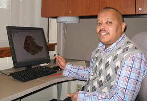 Getachew Berhan Demisse, in his office in Hardin Hall, reviews data on evapotranspiration from the U.S. Geological Survey, which helped fund part of his stay in the U.S.
