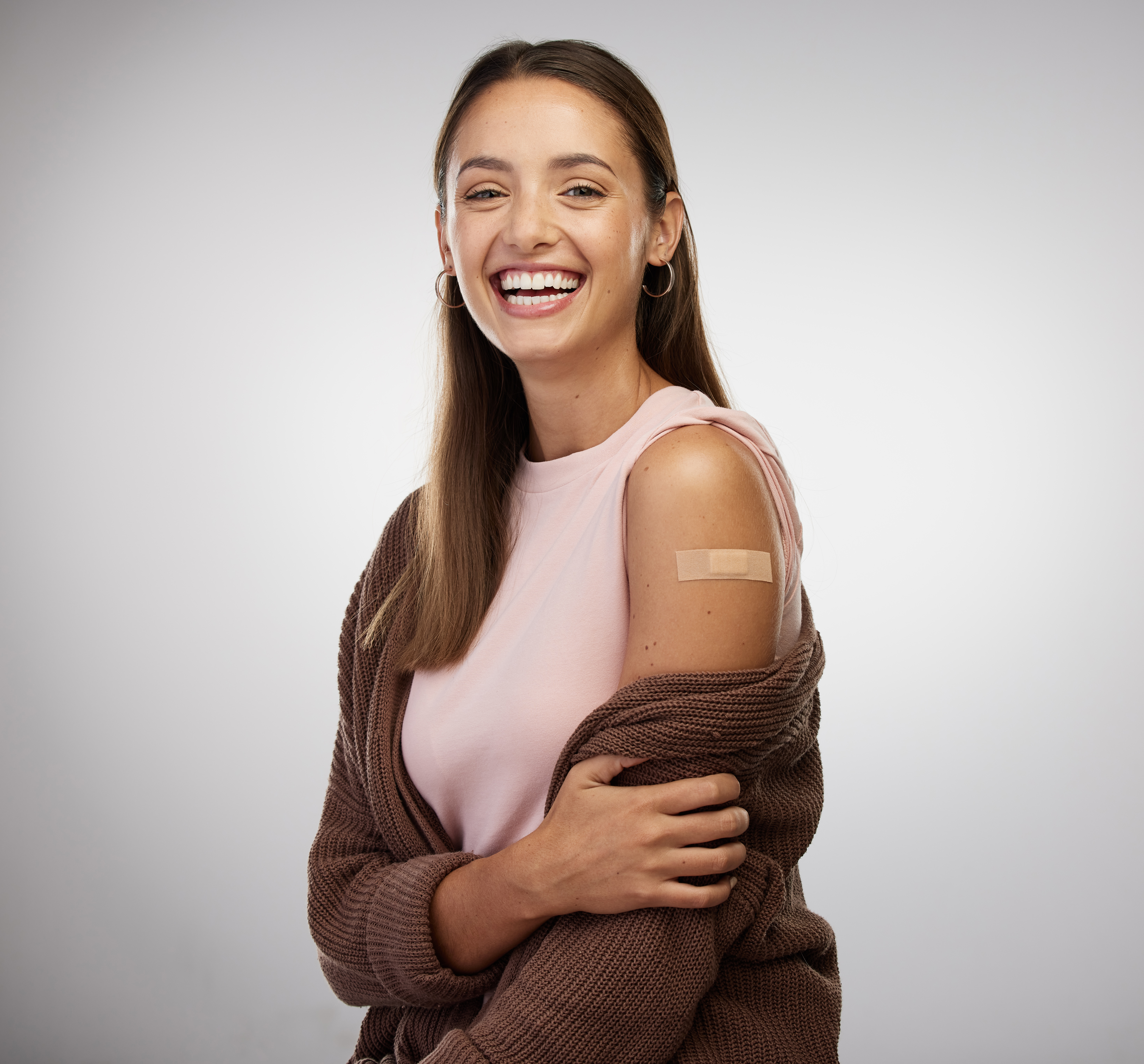 A student shows off their flu shot bandage.