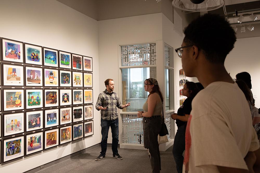 LPS Grad and Award-Winning Visual Artist Trent Claus guides Arts and Humanities students through his exhibition.