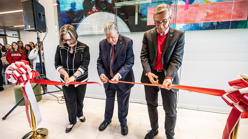  (From left) Sherri Jones, dean of the College of Education and Human Sciences; Rick Edwards, administrator and professor emeritus and Carolyn Pope Edwards’ widower; and Chancellor Ronnie Green cut the ribbon during the opening of Carolyn Pope Edwards Hal