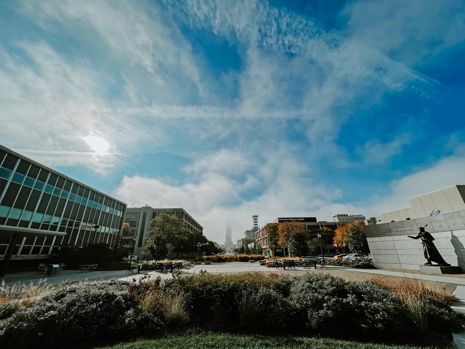 Fog covers the top of the Capitol in the distance in a view from the College of Journalism and Mass Communications.