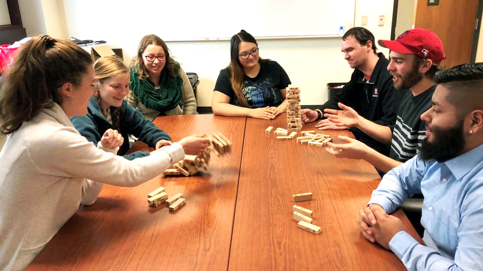 CRE students number the blocks in the game Jenga and play it with special rules to teach resilience concepts. Pictured are (from left) Julie Fowler, Jessica Johnson, Alison Ludwig, Rubi Quiñones, Conor Barnes, Dominic Cristiano and Daniel Morales. 
