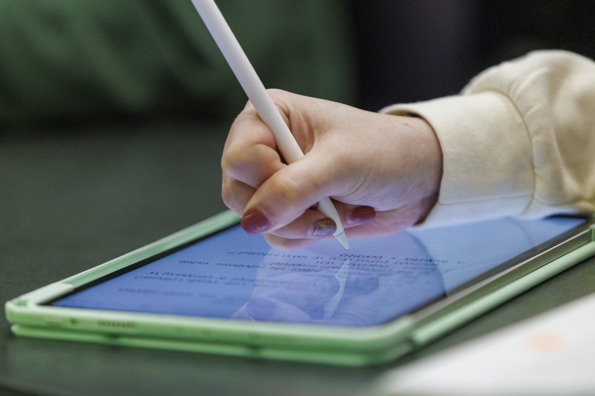 Hand writing on a tablet with a stylus