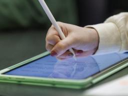 Hand writing on a tablet with a stylus