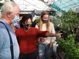 Senior horticulture majors Deanna Montanez Mendoza (second from left) and Jenna Lukas (right) answer Gary Bell’s questions during the Horticulture 307 Hydroponics for Growing Populations class open house Nov. 23, 2021. Lana Koepke Johnson | Department of 