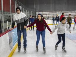 Three UNL students skate at the Breslow Ice Center. [Student Affairs]