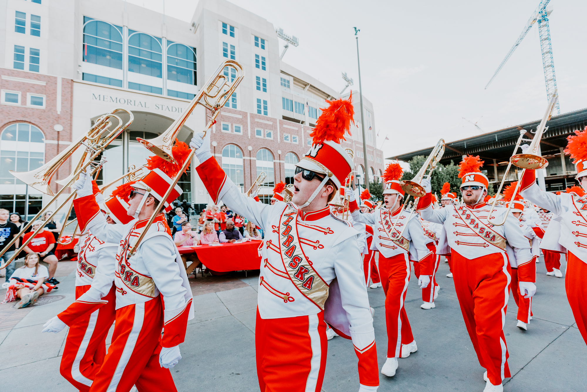 The Cornhusker Marching Band shows their spirit as they march past the judges table in front of Memorial Stadium during the 2022 homecoming parade. 