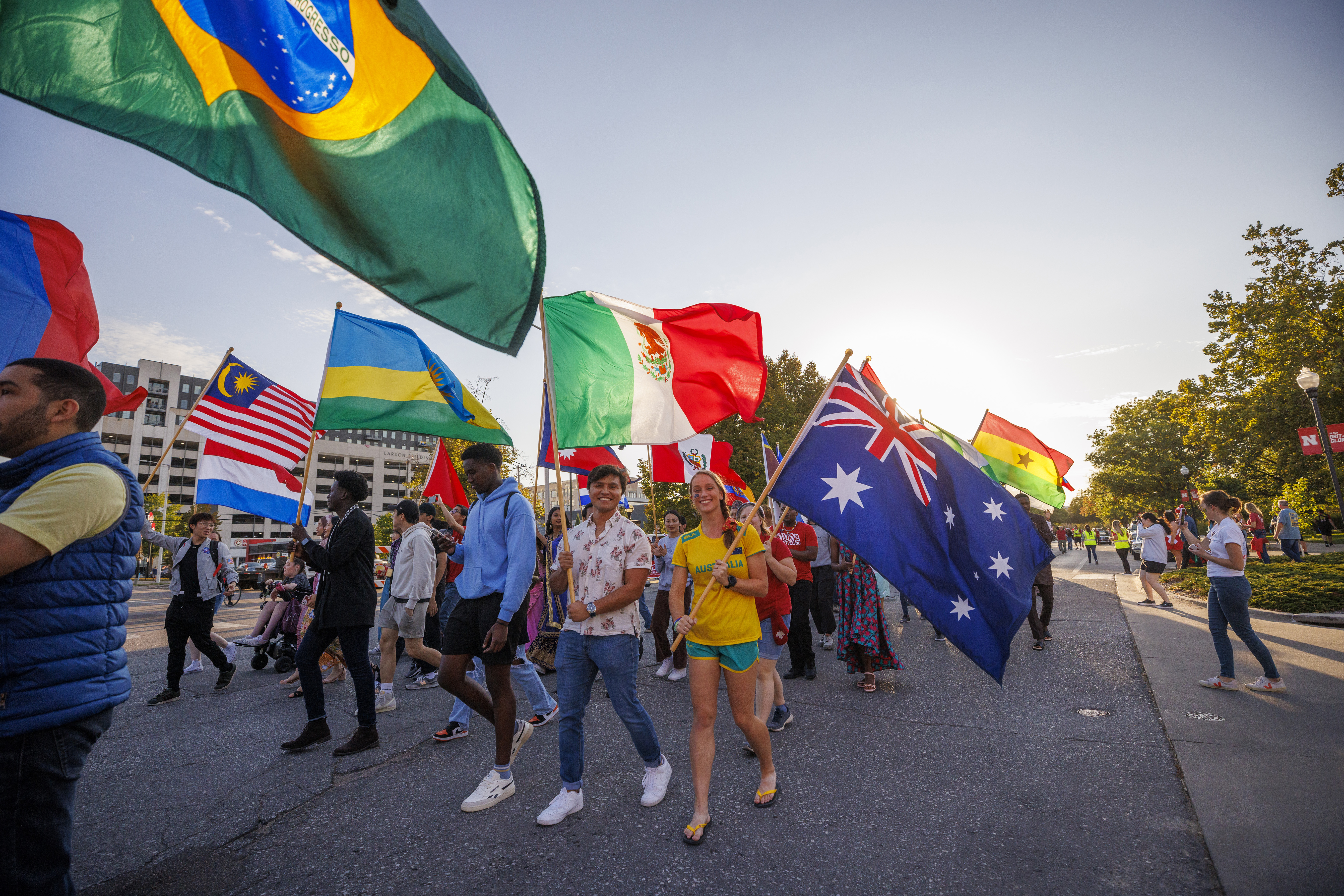 International students carry their flags in the Homecoming Parade and Cornstalk. September 30, 2022. Photo by Craig Chandler / University Communication.