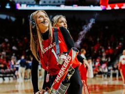 Ashley Beckman works the T-shirt machine on the court during a Husker Basketball game