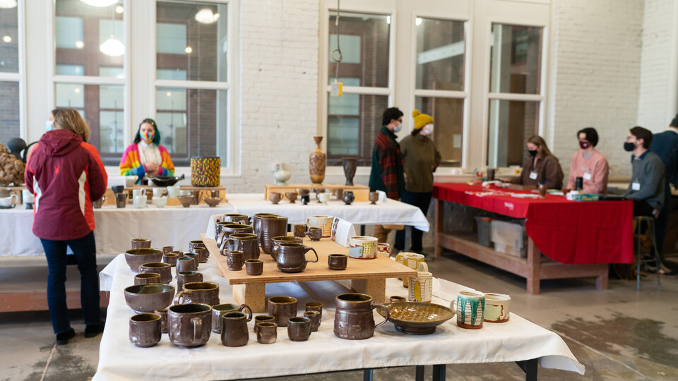 People browse work available for sale at last year’s Clay Club sale. This year’s sales, featuring work made by graduate and undergraduate students in ceramics, photography, printmaking and painting, are Dec. 9-10 in Richards Hall. [courtesy image | Eddy A