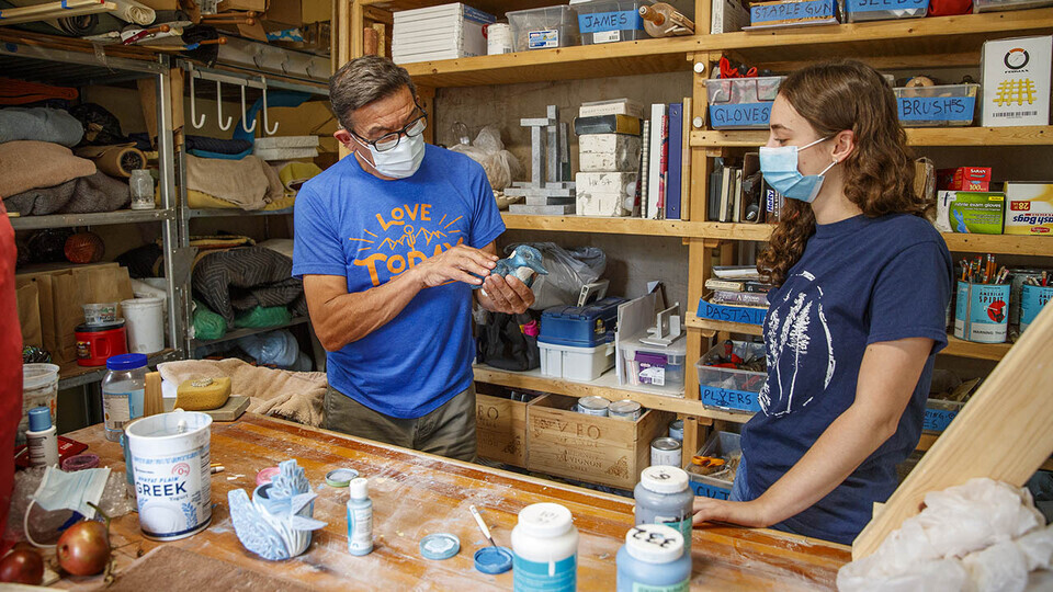  Eddie Dominguez, professor of art, works with UCARE student Kinga Aletto in August 2020.