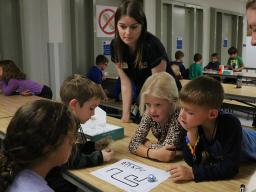  Pictured is Extension Assistant Elizabeth Thiltges teaching afterschool youth how to create code for robots. 