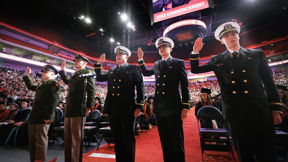 Five Army and Naval ROTC graduates repeat the oath of office during the undergraduate commencement ceremony Dec. 17 at Pinnacle Bank Arena. They are (from left) 2nd Lts. Jack O’Dell and Aubrey Fangmeier, Army; and Ensigns Cohan Bonow, John Carpenter and N