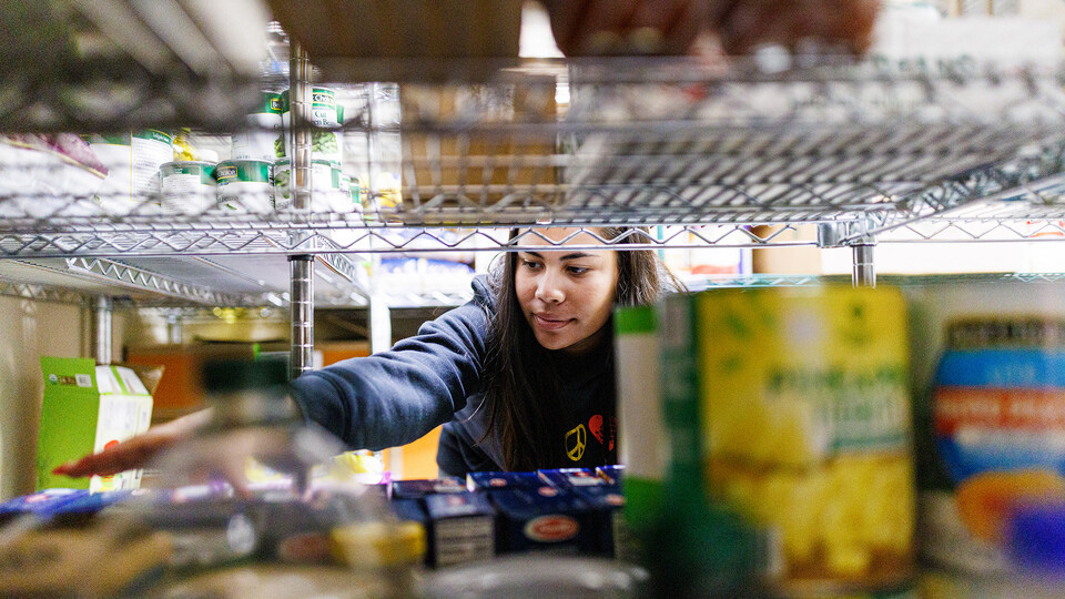 Bree Bell, a freshman from Omaha, sorts food in the storage room at Matt Talbot in January during the month's Engage Lincoln event, which coincided with MLK Week. Engage Lincoln events happen the third week of each month. [Craig Chandler | University Comm