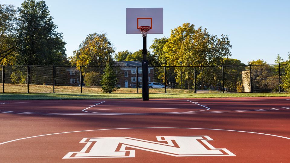 Students can play basketball and sand volleyball at the Rec & Wellness outdoor recreation area.