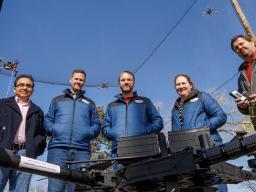 (From left) Francisco Muñoz-Arriola, Justin Bradley, Carrick Detweiler, Brittany Duncan and Trenton Franz pose among unmanned aerial vehicles at the NIMBUS outdoor flying area on Nebraska Innovation Campus. The teams have earned two grants to push the bou