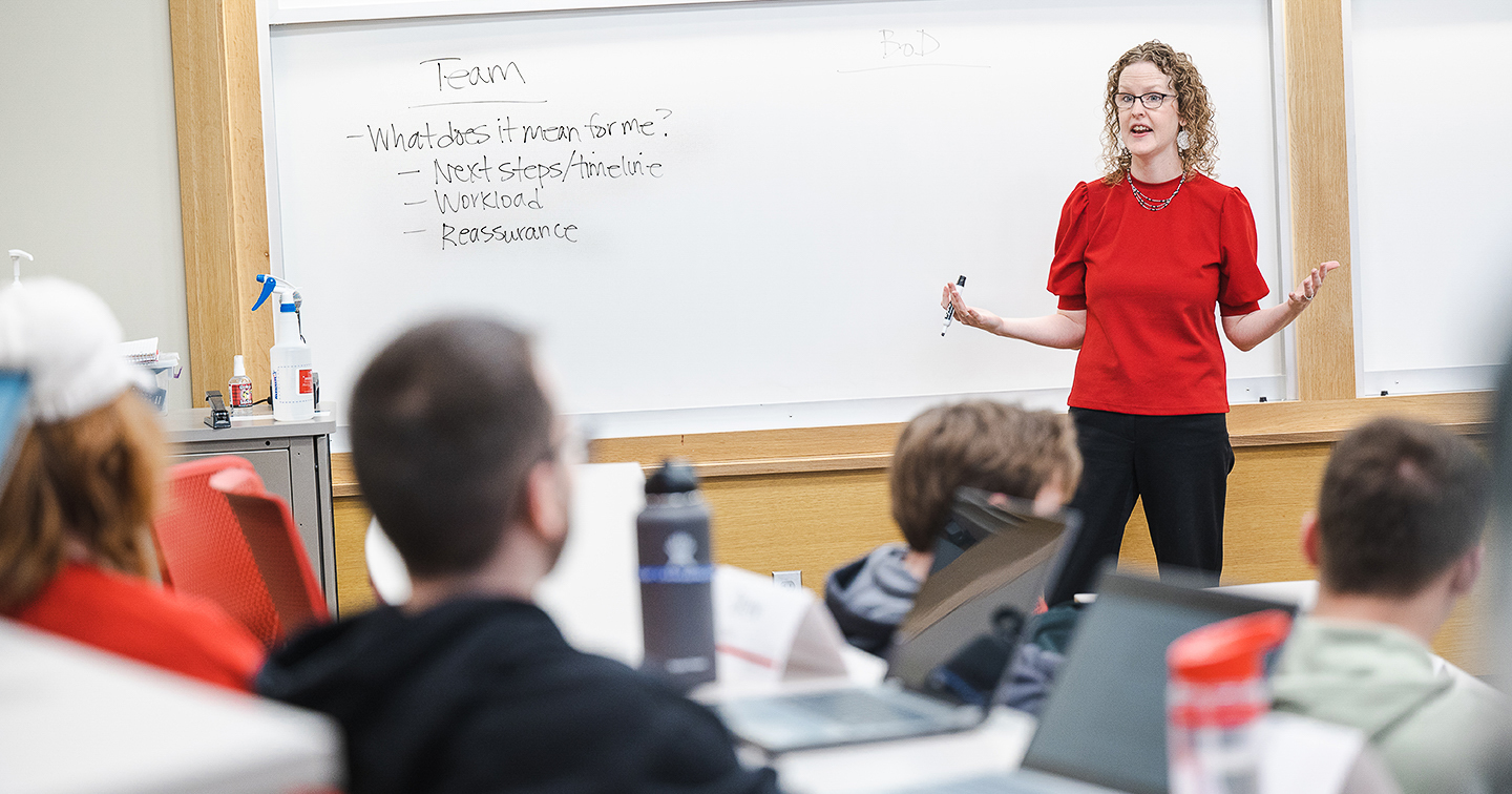 Professor Amanda Gonzales conversing with a student 