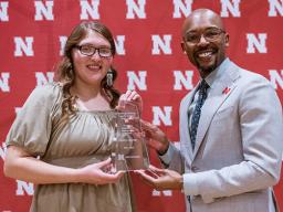 Daelyn Zagurski accepts the Promising Leader: Undergraduate Student award from Marco Barker, vice chancellor of diversity and inclusion. 