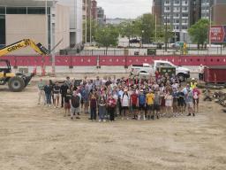Students, faculty and staff in the Glenn Korff School of Music gathered for a group photo at the construction site for the new music building. Photo by Laura Cobb.