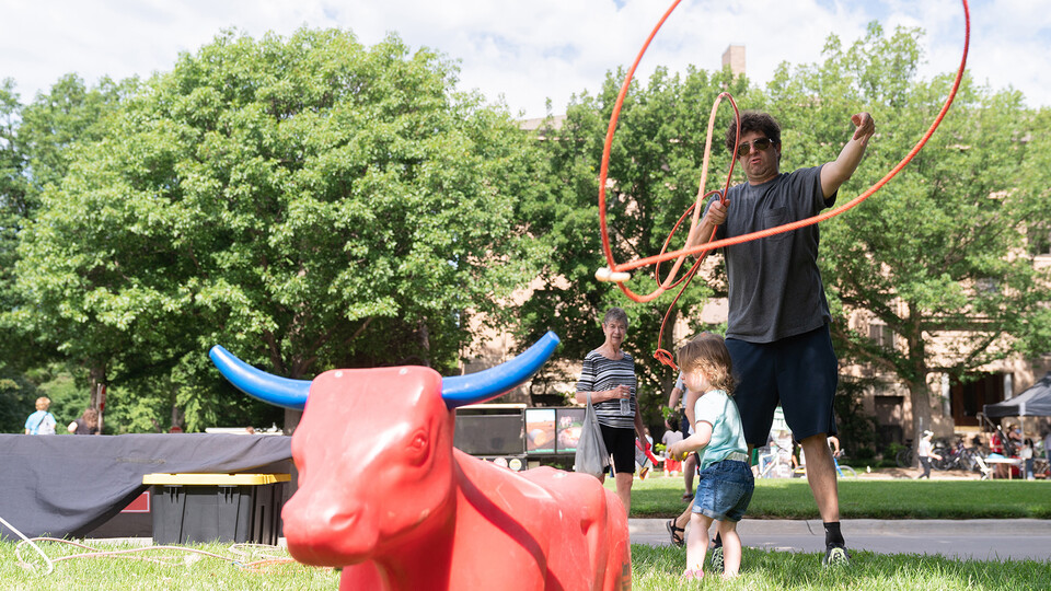  A 2022 East Campus Discovery Days and Farmers Market attendee learns to lasso at the UNL Rodeo Club exhibit. Jordan Opp | University Communication and Marketing  