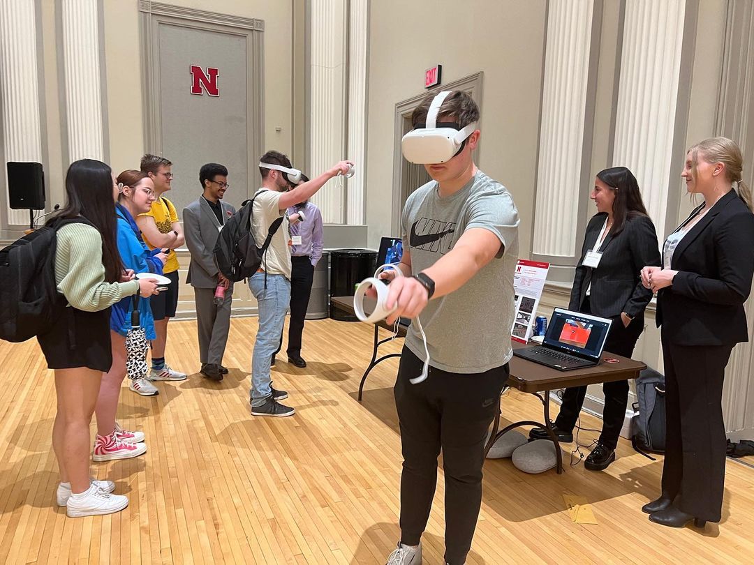 Students present and test a VR project at the 2023 Senior Design Showcase in May.