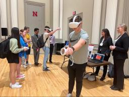 Students present and test a VR project at the 2023 Senior Design Showcase in May.