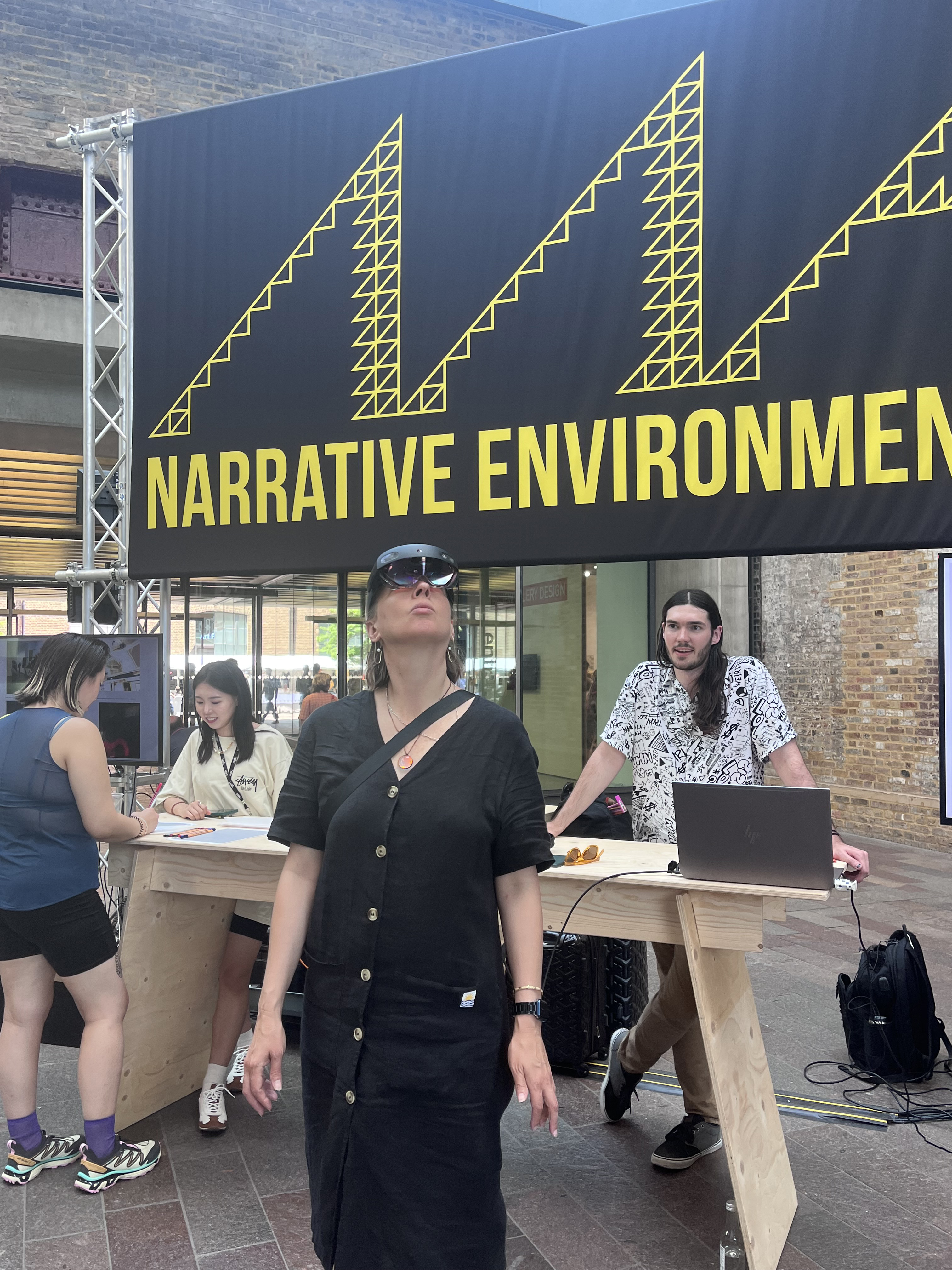 Trystan Nord (right) watches as Assistant Professor of Emerging Media Arts Ash Eliza Smith tries out “Can You See How I See?” in London. Courtesy photo.