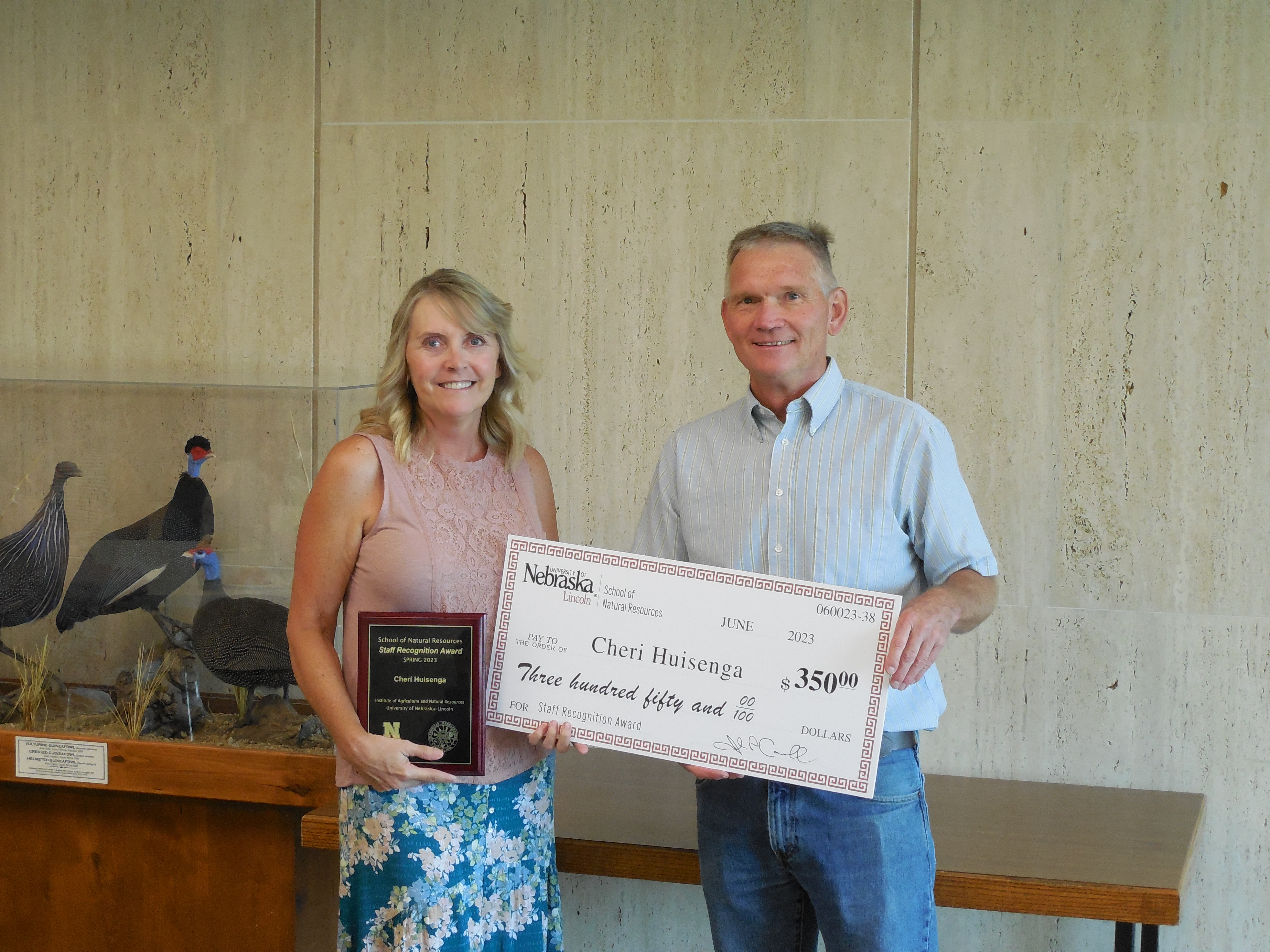 Cheri Huisenga (left) receives the SNR Staff Recognition Award from SNR Director, John Carroll (right).