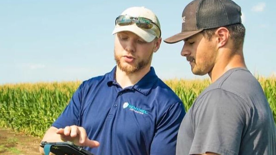 Jackson Stansell (left) works with a client of Sentinel Fertigation. Stansell completed the Introduction to Customer Discovery course through NUtech Ventures in 2021.