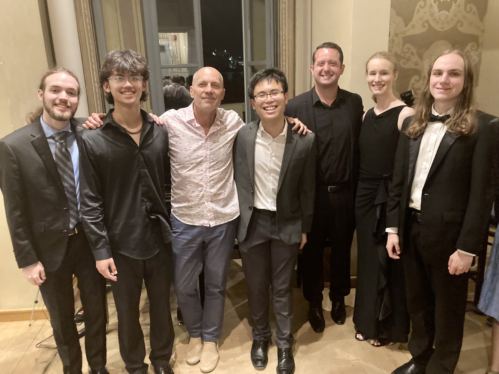 Left to right: Nathaniel Brown, Zachary Jacobsen, Paul Barnes, Khang Nguyen, Andrew Daugherty, Rebekah Stiles and Ben DeLong at a Summer Piano Institute concert in Greece. Courtesy photo.