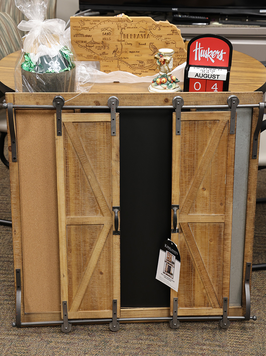 Some of the items for 4-H Council's 2023 Silent Auction, including a Nebraska cutting board and rolling barn door organizer with cork/chalk and magnetic board