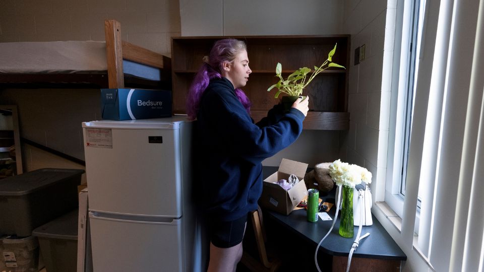 Student decorates residence hall room during move-in.