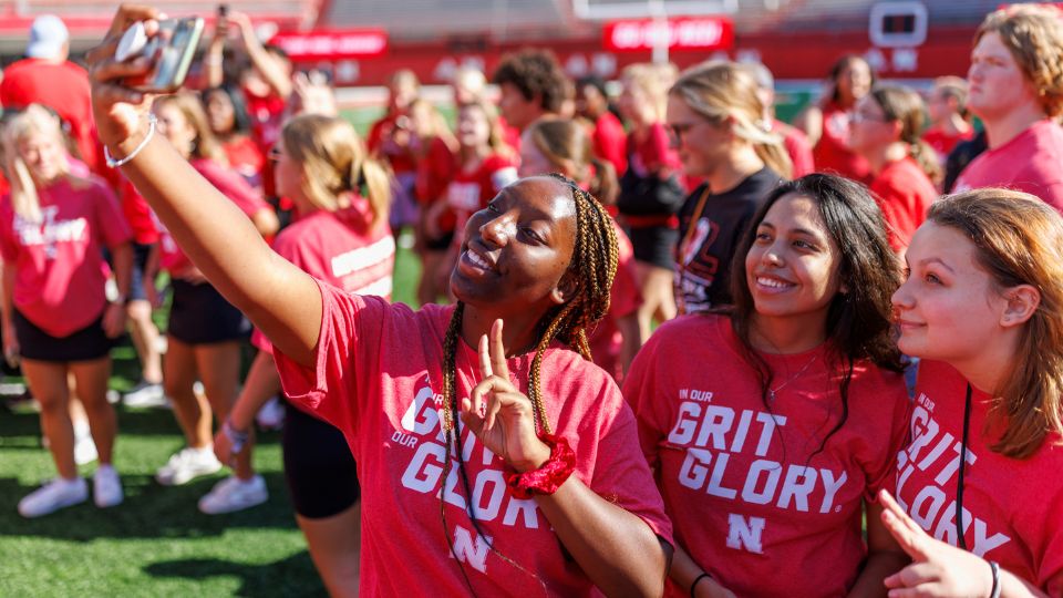 Students take a selfie in Memorial Stadium during New Student Welcome.