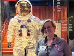 Bobbi Middleton stands in front of the space suit Neil Armstrong wore on the moon. Courtesy photo