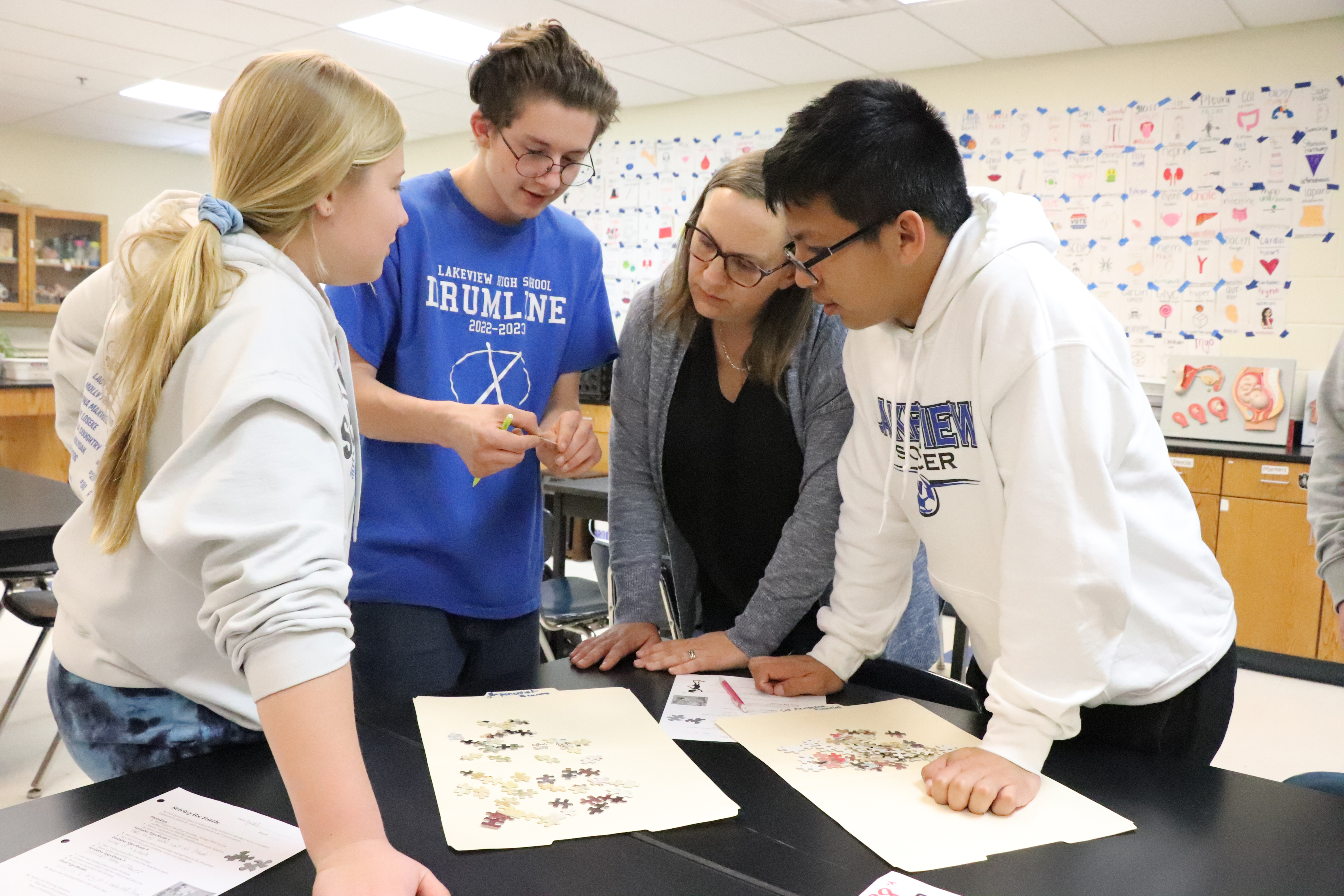 Nicole Miller (second from right) discusses a biology lesson with her students in April 2023. Lindsay Augustyn | UNL CSMCE