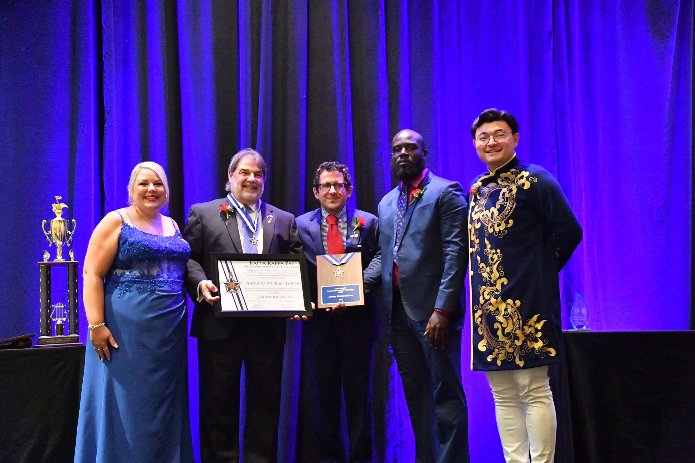 Tony Falcone (second from left) receives the Kappa Kappa Psi Distinguished Service to Music Medal in July. It is the highest award presented by the national honorary band fraternity. Courtesy photo.