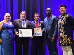 Tony Falcone (second from left) receives the Kappa Kappa Psi Distinguished Service to Music Medal in July. It is the highest award presented by the national honorary band fraternity. Courtesy photo.