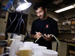 Abdallah Abdallah, a first-year student from Lincoln, documents a spider’s activity while working in Eileen Hebets' lab. Craig Chandler | University Communication and Marketing