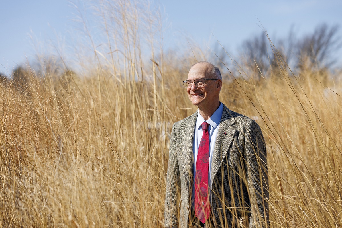 Robert Brooke standing in a field of wheat.