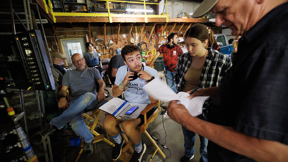 Nebraska student and script supervisor Charlie Major listens to comments by producer Jamie Vesay. At left is Richard Endacott and in the middle right is Grace Birkland, Nebraska student and second assistant cameraperson. Photo by Craig Chandler, Universit